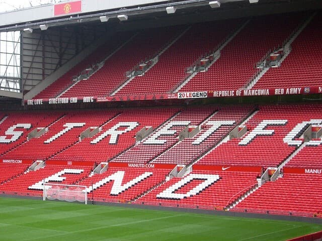 Passionate football fans waving flags in the stands