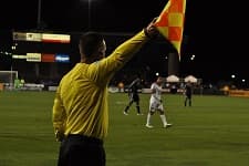 Referee showing a yellow card during a football match